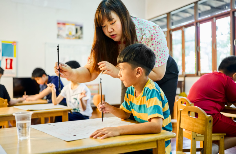 Primary Chinese tuition student practising oral with a tutor